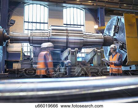 Steel roller on lathe in engineering factory View Large Photo Image Stock Photograph - Steel roller on lathe in engineering factory. Fotosearch