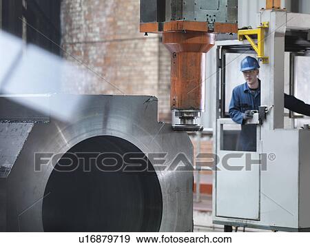 Steelworker cutting steel on gantry milling machine in engineering factory View Large Photo Image Stock Photo - Steelworker cutting steel on gantry milling machine in engineering factory. Fotosearch