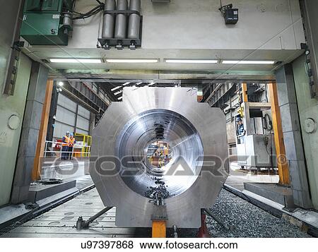 Steelworker cutting steel on gantry milling machine in engineering factory View Large Photo Image Stock Photo - Steelworker cutting steel on gantry milling machine in engineering factory. Fotosearch