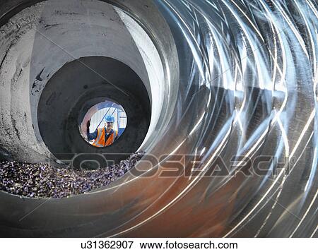 Steelworker inspecting cast steel in engineering factory View Large Photo Image Stock Photo - Steelworker inspecting cast steel in engineering factory. Fotosearch