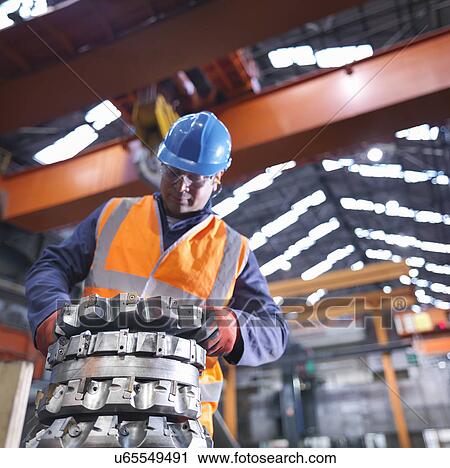 Steelworker lifting cutting tool in engineering factory View Large Photo Image Stock Image - Steelworker lifting cutting tool in engineering factory. Fotosearch