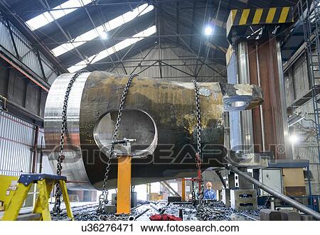 Stock Image - Steelworker milling large casting. Fotosearch