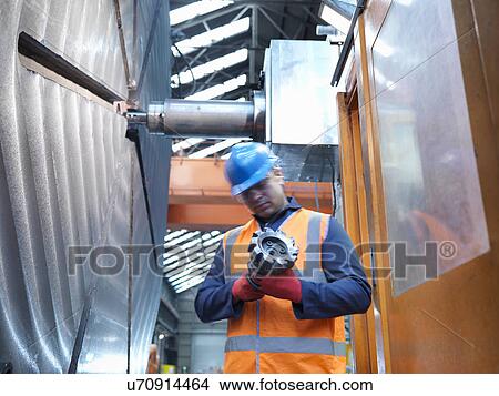 "Steelworker with cutting tool, low angle view" View Large Photo Image Picture - "Steelworker with cutting tool, low angle view". Fotosearch