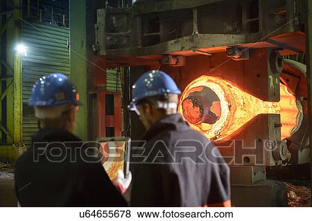 "Steelworkers using digital tablet with 10, 000 tonne forging press in steelworks" View Large Photo Image Stock Photo - "Steelworkers using digital tablet with 10, 000 tonne forging press in steelworks". Fotosearch