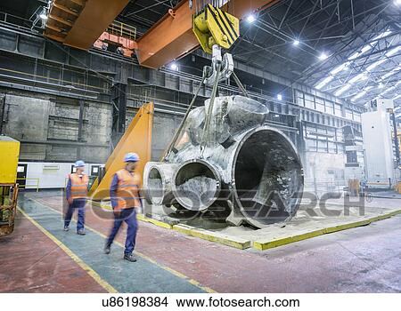 Picture - Steelworkers walking past large casting. Fotosearch