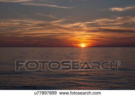 Stock Photo - "Sunset and sea, Oristano, Sardinia, Italy". Fotosearch