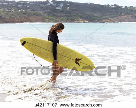 Stock Photo - "Surfer enjoying beach, Roadknight, Victoria, Australia". Fotosearch
