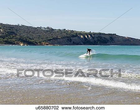 Stock Image - "Surfer in sea, Roadknight, Victoria, Australia". Fotosearch