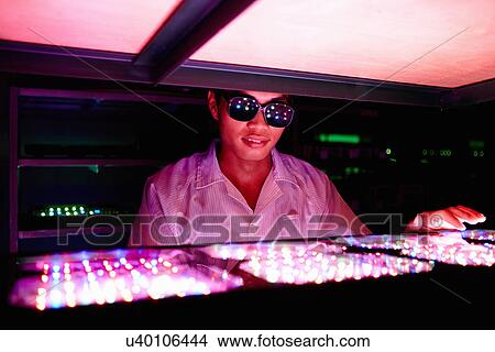 Technician wearing protective goggles in LED factory View Large Photo Image Picture - Technician wearing protective goggles in LED factory. Fotosearch