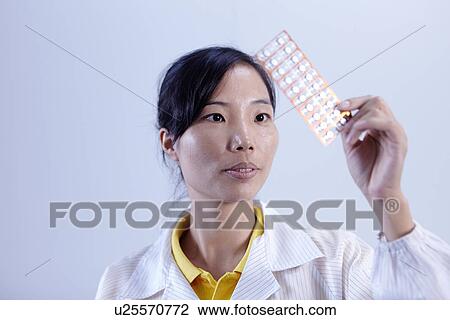 Stock Image - Technician working in LED factory. Fotosearch