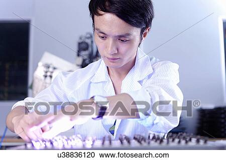 Technician working in LED factory View Large Photo Image Stock Image - Technician working in LED factory. Fotosearch