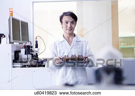 Technician working in LED factory View Large Photo Image Stock Image - Technician working in LED factory. Fotosearch