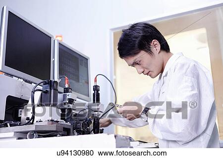 Technician working in LED factory View Large Photo Image Stock Image - Technician working in LED factory. Fotosearch