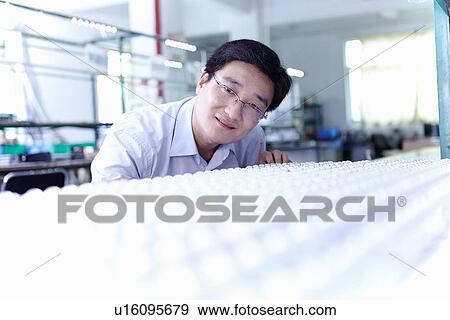 Technician working in LED factory View Large Photo Image Stock Photo - Technician working in LED factory. Fotosearch