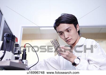 Technician working in LED factory View Large Photo Image Stock Photo - Technician working in LED factory. Fotosearch