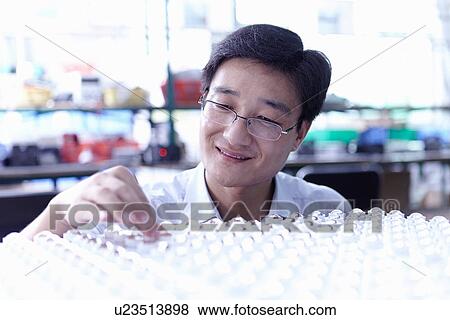 Stock Photo - Technician working in LED factory. Fotosearch
