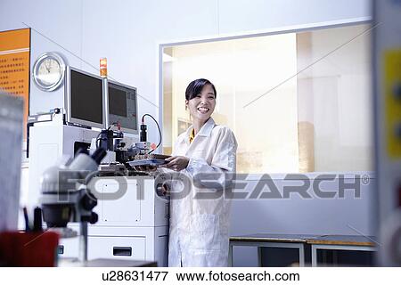 Stock Photo - Technician working in LED factory. Fotosearch
