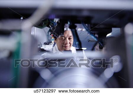 Technician working in LED factory View Large Photo Image Stock Photo - Technician working in LED factory. Fotosearch