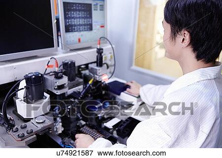 Technician working in LED factory View Large Photo Image Stock Photo - Technician working in LED factory. Fotosearch