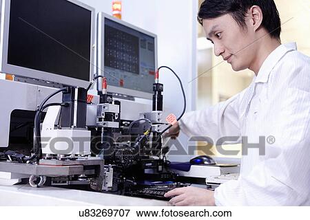 Technician working in LED factory View Large Photo Image Stock Photo - Technician working in LED factory. Fotosearch
