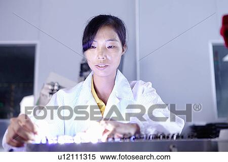 Stock Photography - Technician working in LED factory. Fotosearch
