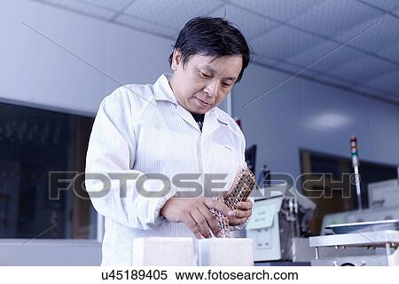 Technician working in LED factory View Large Photo Image Stock Photography - Technician working in LED factory. Fotosearch