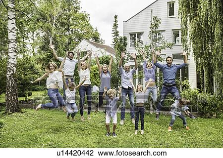 Three generational family jumping in garden View Large Photo Image Stock Image - Three generational family jumping in garden. Fotosearch