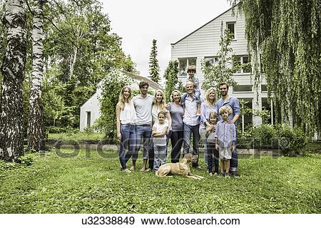 Stock Photo - Three generational family standing in garden. Fotosearch