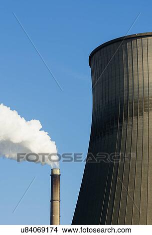 Picture - Top of smoke stack and cooling tower with blue sky. Fotosearch