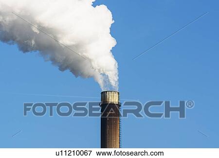 Stock Photo - Top of smoke stack with blue sky. Fotosearch