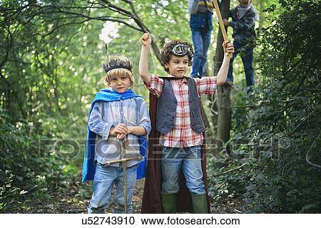 Two boys dressed up and playing in forest View Large Photo Image Stock Image - Two boys dressed up and playing in forest. Fotosearch