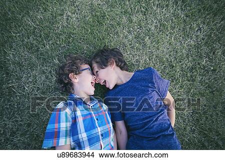 Two boys face to face on garden grass View Large Photo Image Picture - Two boys face to face on garden grass. Fotosearch