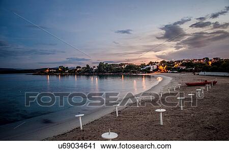 Stock Image - "View of beach and coast at sunset, Olbia, Sardinia, Italy". Fotosearch