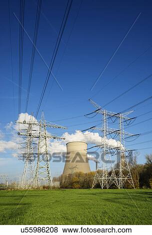 Stock Photo - View of electrical towers in front of cooling towers and smoke stacks. Fotosearch