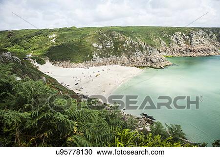 Stock Image - "View of holiday makers on beach, Porthcurno, Cornwall, UK". Fotosearch