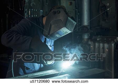 Stock Image - Welder soldering iron in workshop. Fotosearch