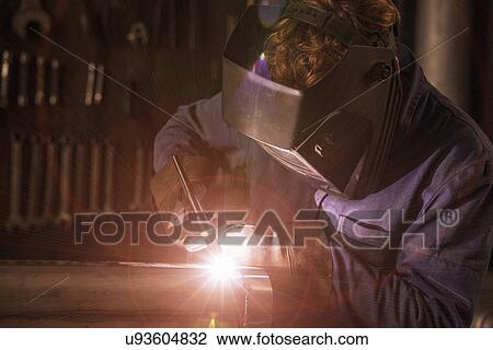 Stock Image - Welder soldering iron in workshop. Fotosearch
