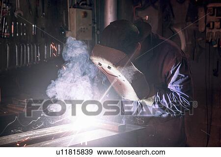 Welder soldering iron in workshop View Large Photo Image Stock Photo - Welder soldering iron in workshop. Fotosearch
