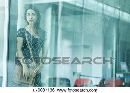 Stock Photograph - Woman behind glass window. Fotosearch
