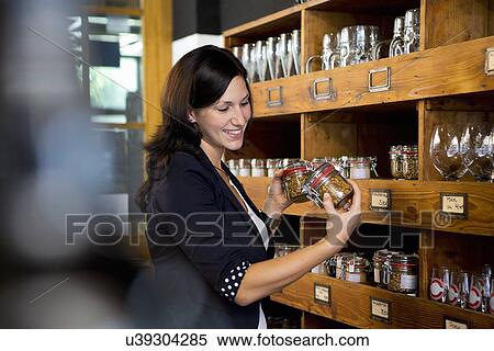 Woman comparing jars in shop View Large Photo Image Stock Photography - Woman comparing jars in shop. Fotosearch