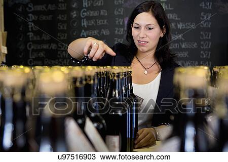 Woman counting bottles of wine in shop View Large Photo Image Stock Image - Woman counting bottles of wine in shop. Fotosearch