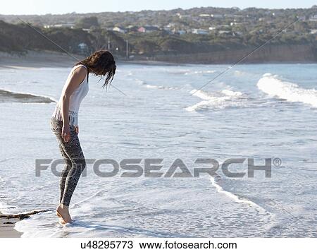 Stock Image - "Woman enjoying beach, Roadknight, Victoria, Australia". Fotosearch