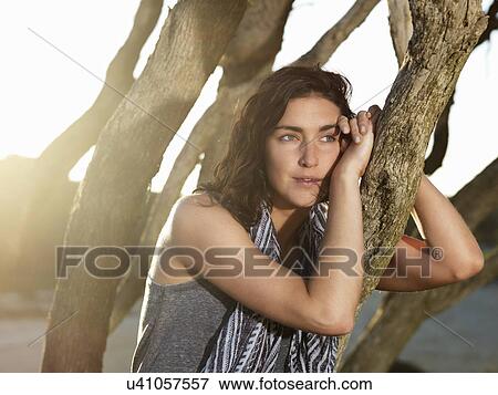 "Woman relaxing by trees, Roadknight, Victoria, Australia" View Large Photo Image Stock Photo - "Woman relaxing by trees, Roadknight, Victoria, Australia". Fotosearch