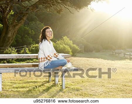 "Woman resting on park bench, Roadknight, Victoria, Australia" View Large Photo Image Stock Photograph - "Woman resting on park bench, Roadknight, Victoria, Australia". Fotosearch