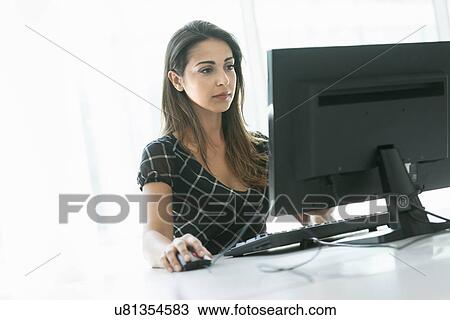 Stock Image - Woman using computer. Fotosearch