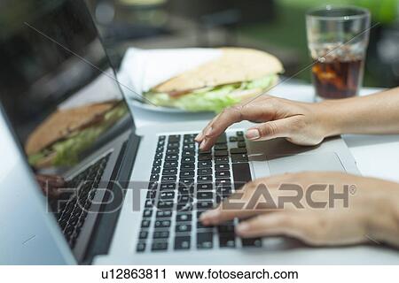 Woman using laptop on working lunch View Large Photo Image Stock Image - Woman using laptop on working lunch. Fotosearch
