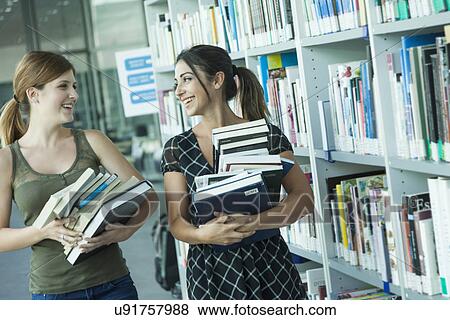 Stock Photo - Women studying in the library. Fotosearch