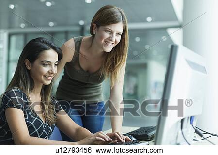Women using computer in the library View Large Photo Image Stock Photograph - Women using computer in the library. Fotosearch