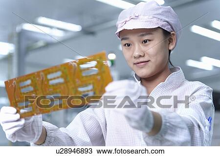Worker holding circuit in factory that specialises in creating functional circuits on flexible surfaces View Large Photo Image Stock Image - Worker holding circuit in factory that specialises in creating functional circuits on flexible surfaces. Fotosearch
