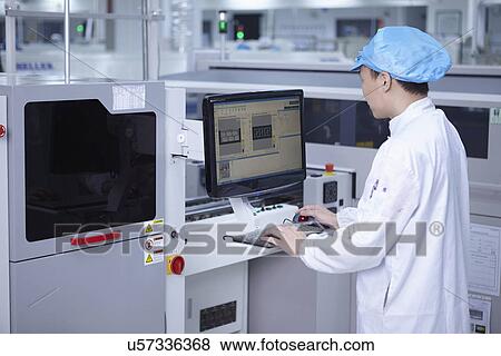 Worker using computer in factory that specialises in creating functional circuits on flexible surfaces View Large Photo Image Stock Photo - Worker using computer in factory that specialises in creating functional circuits on flexible surfaces. Fotosearch